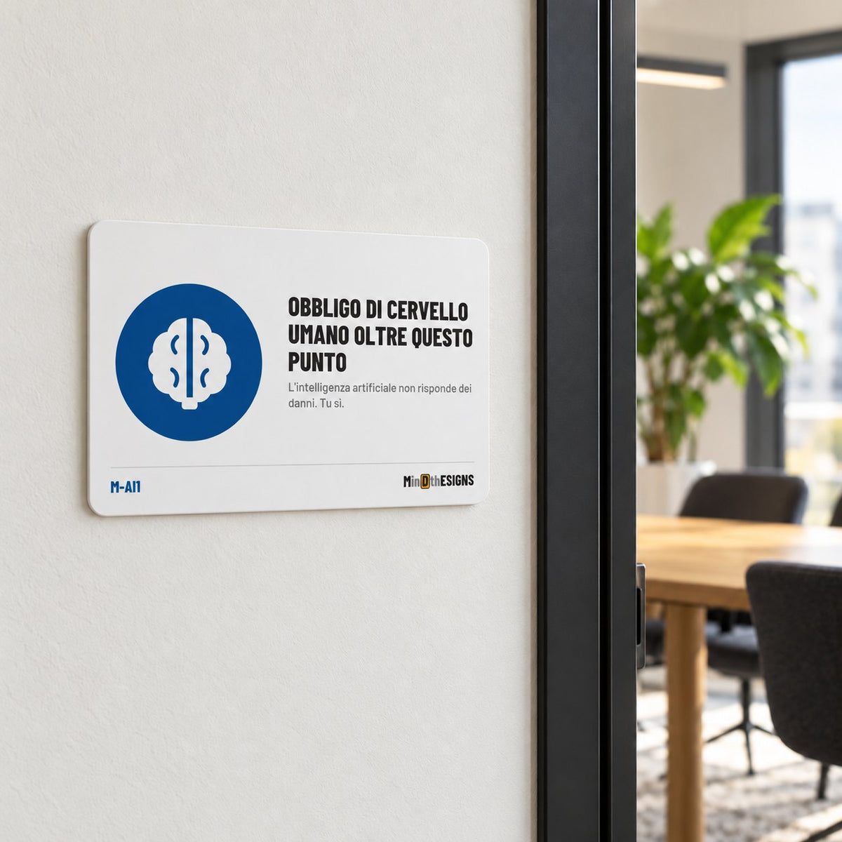 MindTheSigns funny sign “Human Brain Required Beyond This Point” in Italian, aluminium 30×20 cm, shown on an office wall